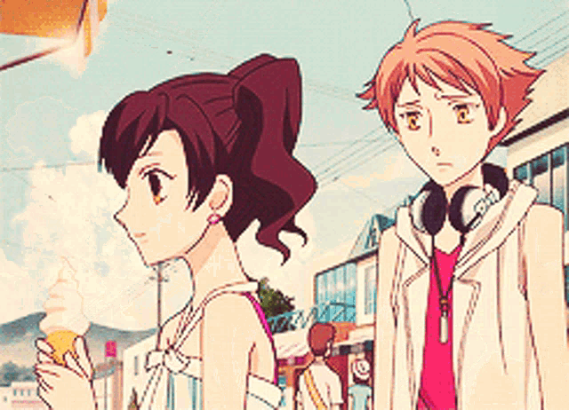 a girl is holding an ice cream cone while standing next to a boy