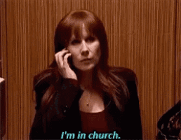 a woman is talking on a cell phone and says i 'm in church