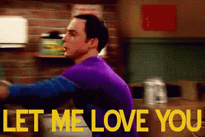 a man in a purple shirt is standing in front of a sign that says " let me love you "