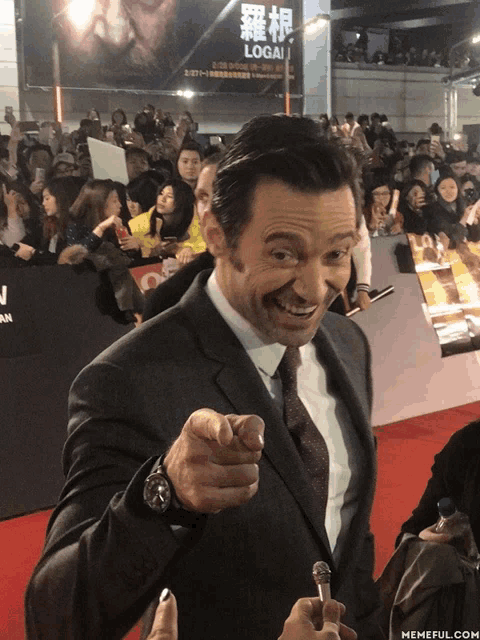 a man in a suit and tie is pointing at something
