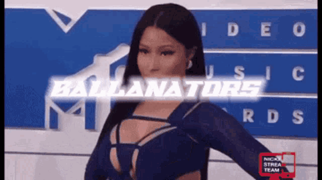 a woman in a blue dress stands in front of a wall that says ballanators