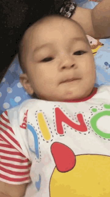 a baby wearing a shirt that says ' king ' on it