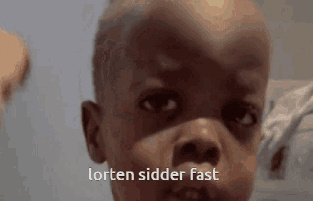 a close up of a child 's face with the words lorten sidder fast written on the bottom
