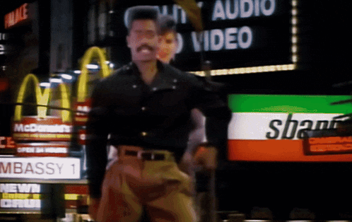 a man stands in front of a sign that says " audio video "