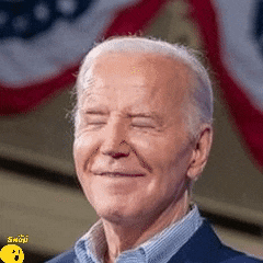 a close up of a man 's face with his eyes closed and a flag in the background .