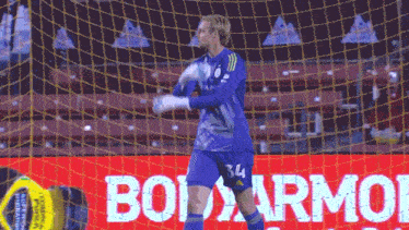 a soccer player in a blue jersey with the number 34 on it