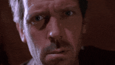 a close up of a man 's face with a beard