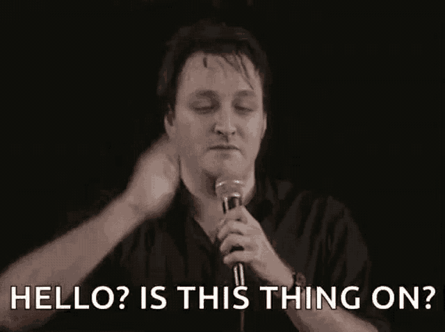 a man is holding a microphone and talking into it .