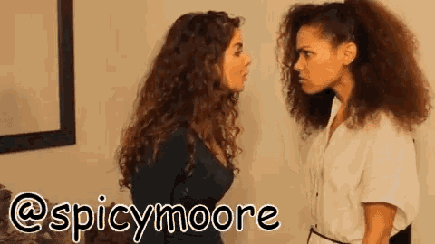 two women are standing next to each other with the words spicymoore written on the bottom