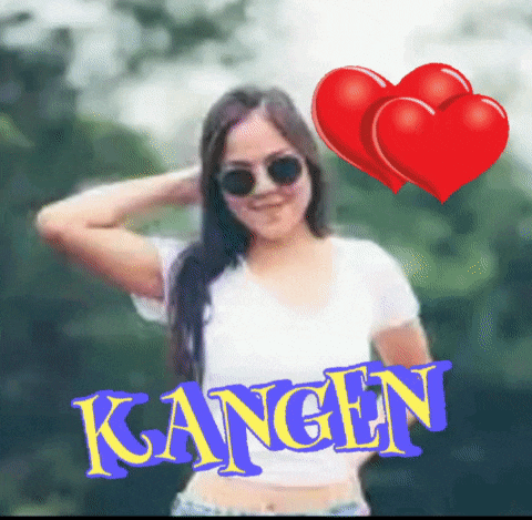 a woman wearing sunglasses and a white shirt has kangen written on her chest