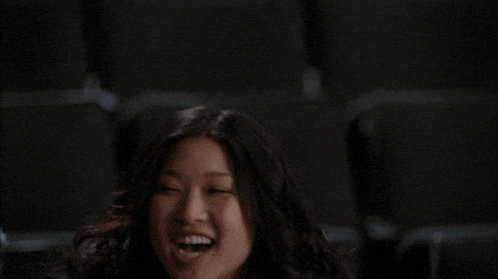 a woman is laughing with her mouth wide open
