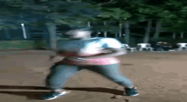 a person is laying on their back on the ground in a park .