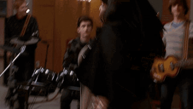 a woman playing a trombone in front of a group of people