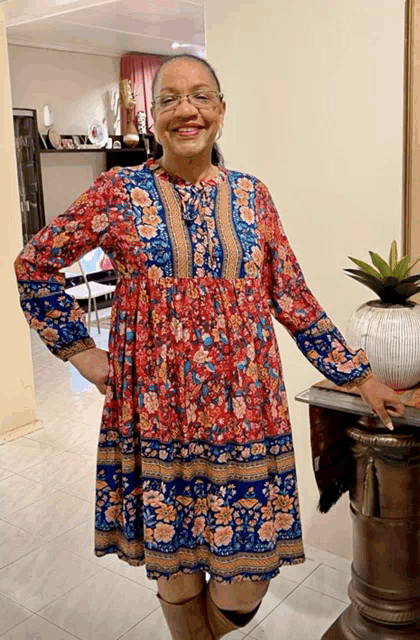 a woman in a red and blue floral dress