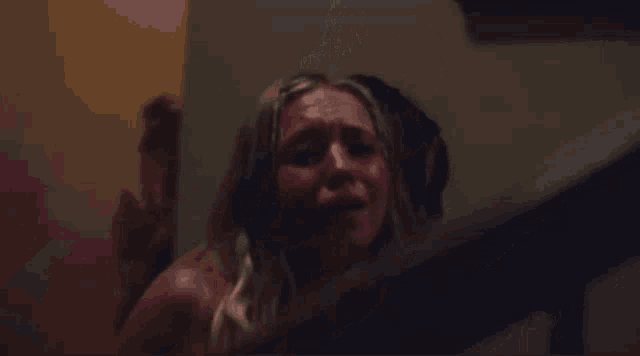 a woman in a pink bikini is being held by another woman on a set of stairs