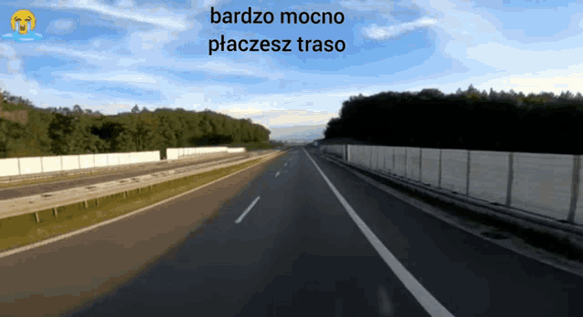 a picture of a highway with the words bardzo mocno placesz traso