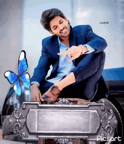 a man in a suit is sitting on a stool with a butterfly behind him