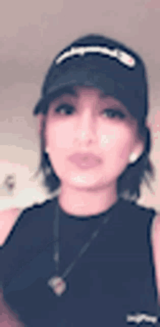 a woman is wearing a hat and a necklace .