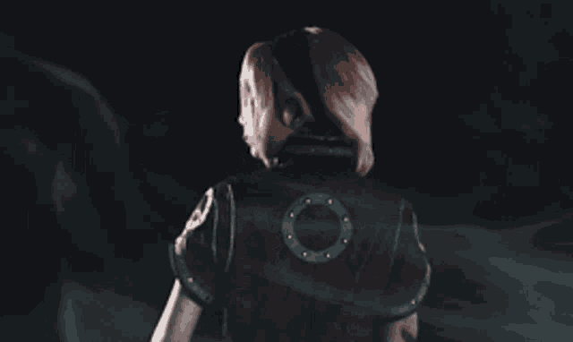 a woman with pink hair is wearing a black shirt