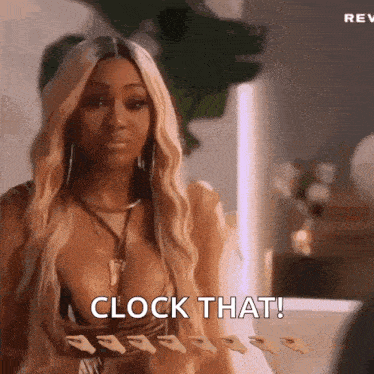 a woman in a plunging neckline top is holding a clock and says clock that .