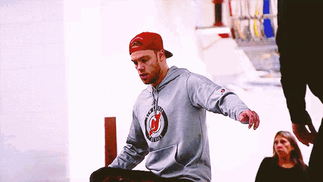 a man wearing a gray hoodie with the letter n on it