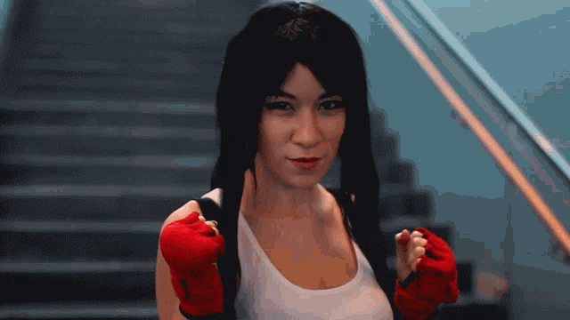 a woman wearing a red boxing glove is smiling