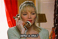 a woman is talking on a telephone and says " who is this "