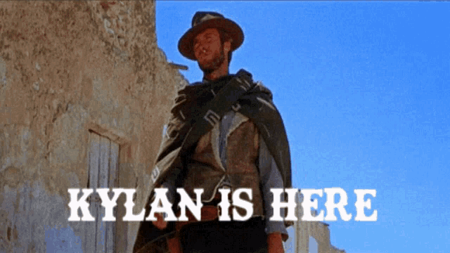 a man standing in front of a building with the words kylan is here