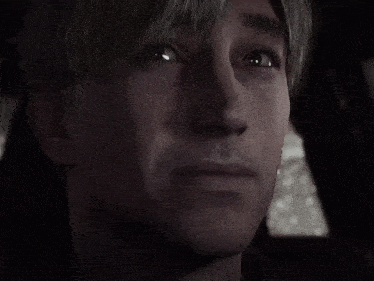 a close up of a man 's face in a dark room .
