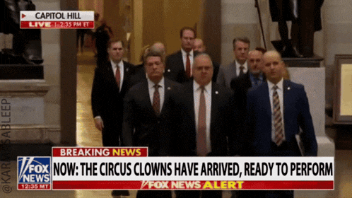 a group of men in suits and ties are walking down a hallway with a fox news breaking news headline