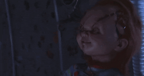 a creepy doll with blood coming out of its head