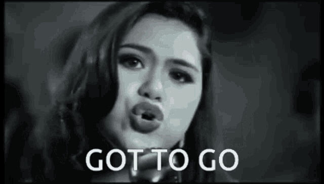 a woman is blowing a kiss in a black and white photo with the words `` got to go '' .