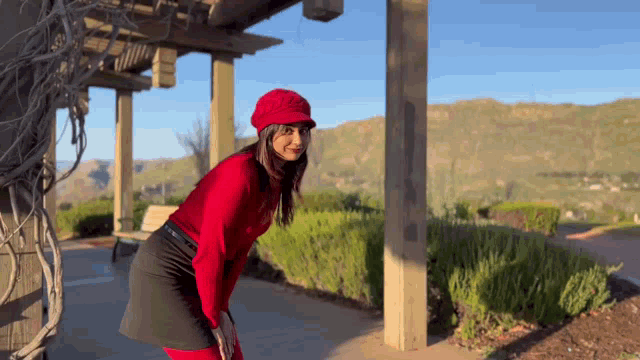 a woman wearing a red hat and a red shirt