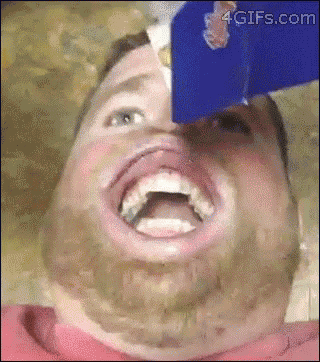 a man with a beard is pouring milk into his mouth and making a funny face ..