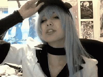 a woman with long blue hair is wearing a hat and a choker