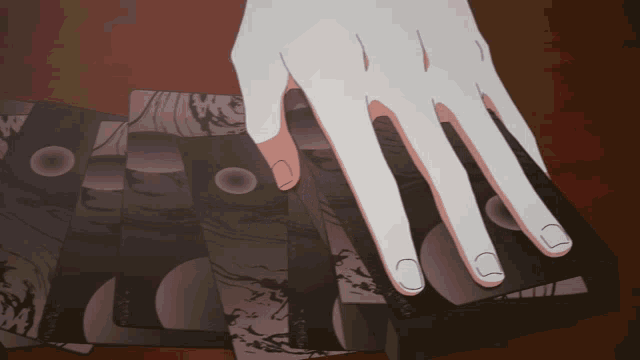 a person 's hand is holding a stack of playing cards with the letter w on them