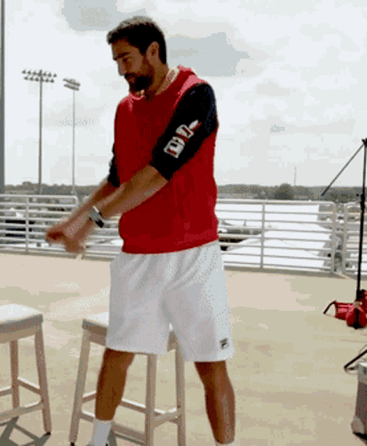 a man wearing a red vest with the number 99 on his sleeve