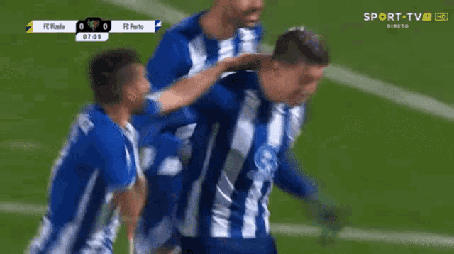 a group of soccer players are celebrating a goal during a game sponsored by sport tv