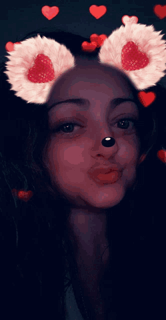 a woman wearing a snapchat filter with hearts and flowers on her ears