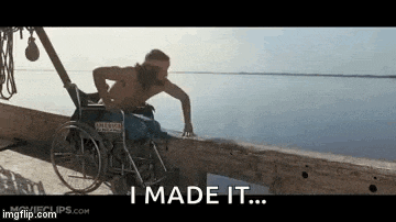 a man in a wheelchair is standing next to a body of water and saying `` i made it '' .