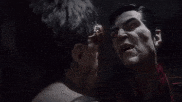 a man wearing goggles is being attacked by another man