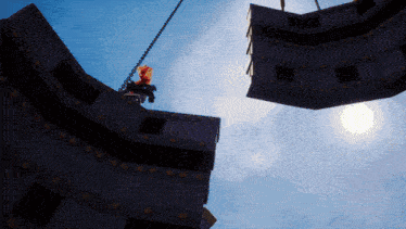 a person is hanging from a chain in the air