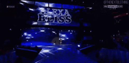 alexa bliss is walking down the aisle of a wrestling ring