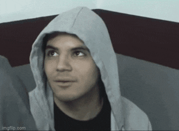 a man wearing a hoodie is looking up at the camera .