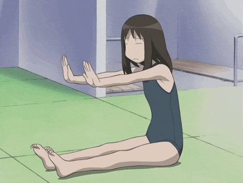 a girl in a blue swimsuit sits on the floor with her legs crossed