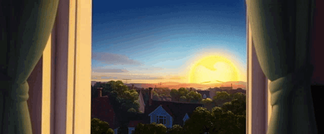 a view of a sunset through a window with houses in the background