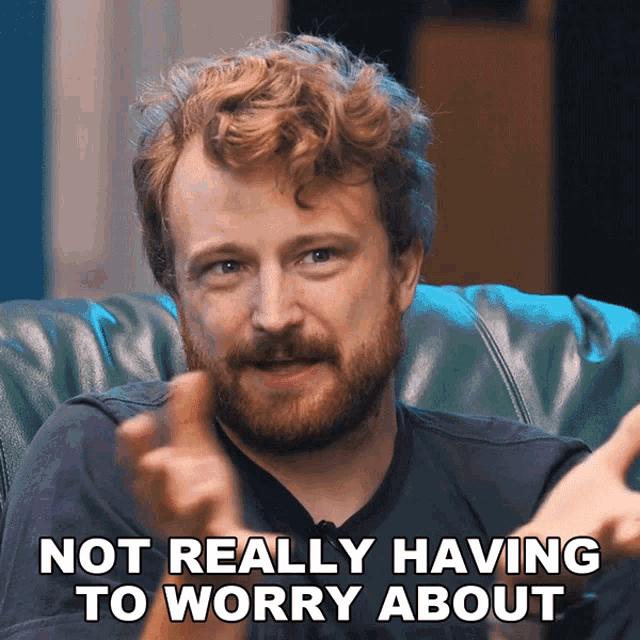 a man sitting on a couch with the words not really having to worry about written below him