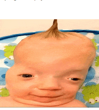 a baby with a ponytail on his head is smiling