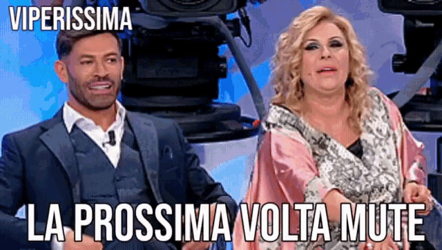 a man and a woman are sitting next to each other with the words viperissima la prossima volta mute written above them