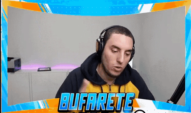 a man wearing headphones is sitting in front of a screen that says bufarete